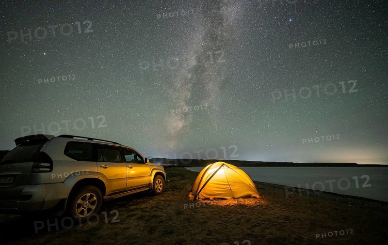 Off-road vehicle and tent, night shot, Milky Way at Lake Issyk Kul, Kyrgyzstan, Asia