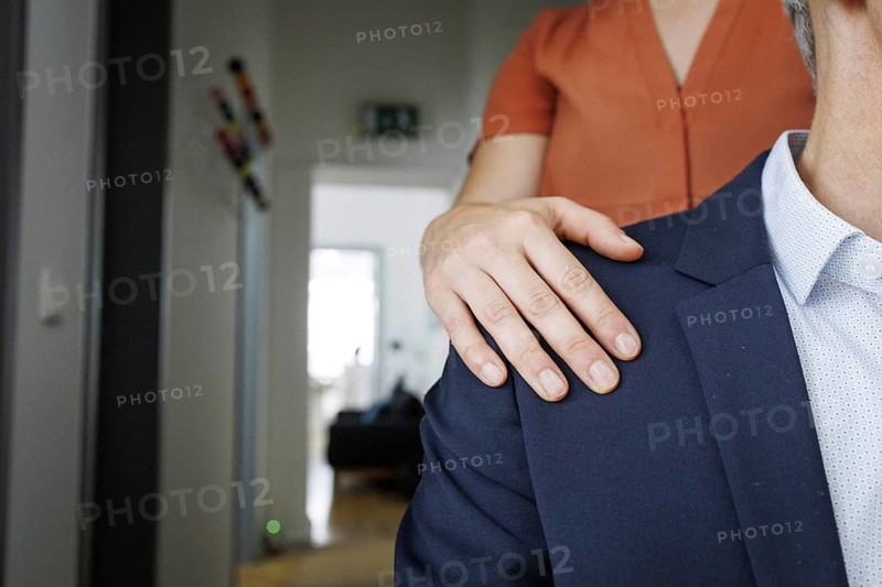 Harassment in the workplace. A woman puts her hand on the shoulder of a man in an office in Berlin, 09/08/2024