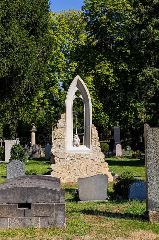 A new monument can be seen at Caspar David Friedrich's grave in Dresden's Trinitatisfriedhof cemetery to mark the 250th birthday of the most famous Romantic artist. The Gothic church window made of sandstone with an owl in rear view on the ledge. The construction was supported by the actor and Friedrich admirer Tom Pauls, Grave of Caspar David Friedrich, Dresden, Saxony, Germany, Europe