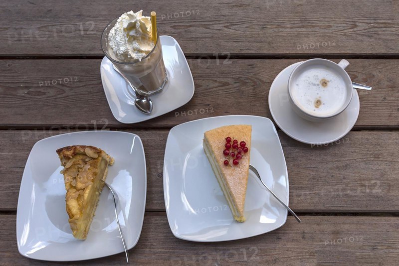Cake and iced coffee with cream and cappuccino on a wooden table, Mecklenburg-Vorpommern, Germany, Europe