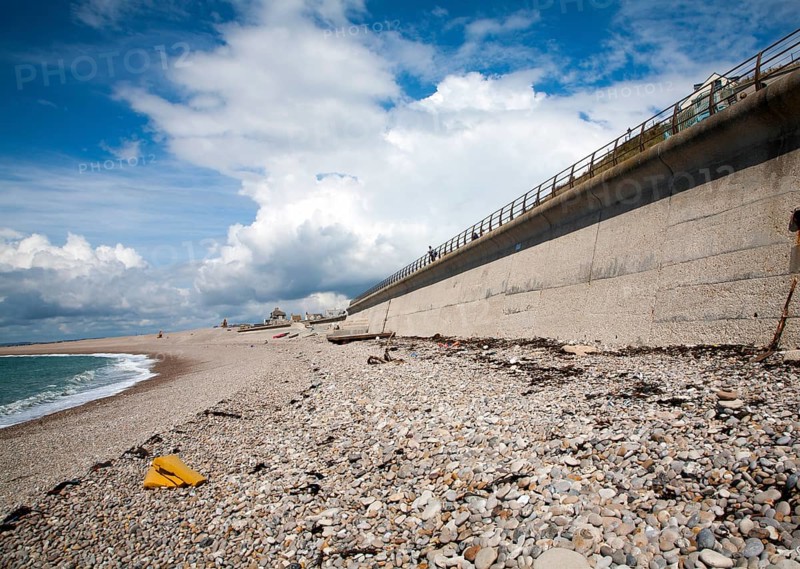 Shingle beach and large sea wall providing coastal defence at Chiswell, Isle of Portland, Dorset, England, UK