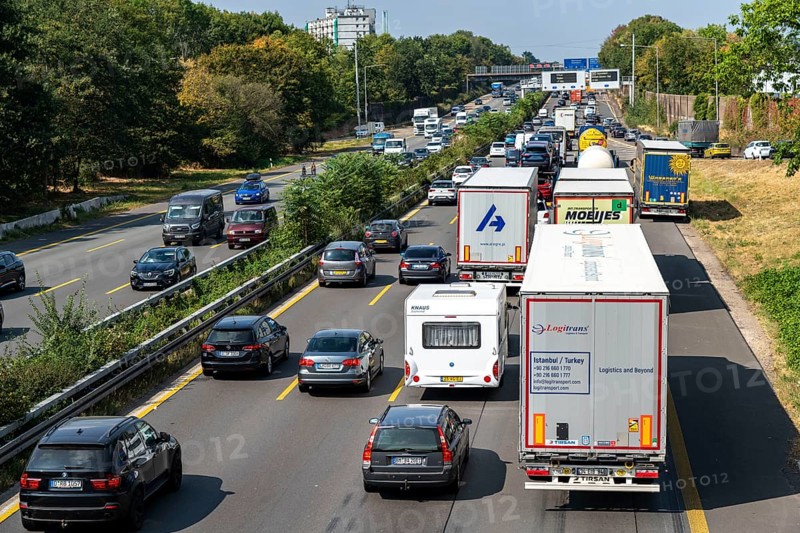 Traffic jam on the A3 motorway, over 8 lanes, in both directions, in front of the Leverkusen motorway junction, Friday afternoon high traffic volume, roadworks, gantry signs with journey times, delays due to the traffic jam, Leverkusen, North Rhine-Westphalia, Germany, Europe