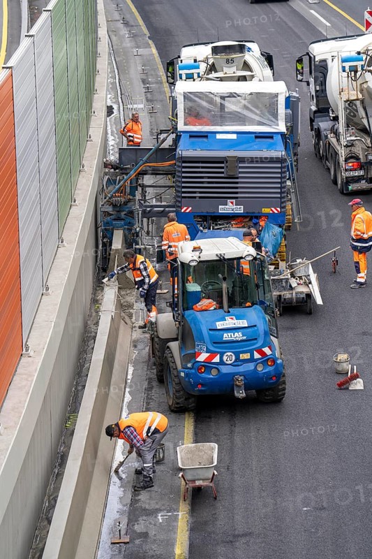 Motorway construction site on the A52 in Essen, basic renovation of the two carriageways in both directions, over 8 years, here the construction of concrete crash barriers between the carriageways, using the so-called sliding construction method, around 500 metres of concrete crash barrier, crash barrier is built per day, North Rhine-Westphalia, Essen
