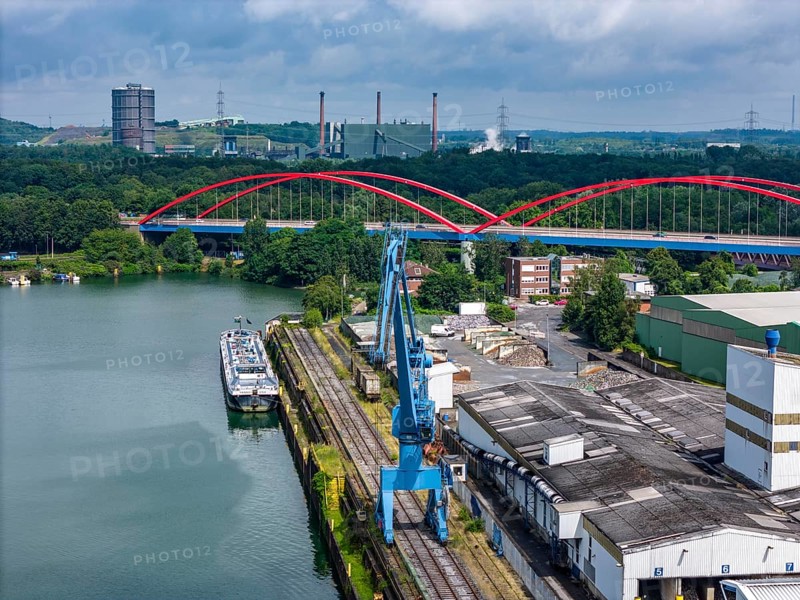 DefaultThe city harbour in the north of Essen, on the Rhine-Herne Canal, North Rhine-Westphalia, Germany, The city harbour in the north of Essen, dilapidated bridge of the A42 over the canal, ArcelorMittal's coking plant in the background, Prosper coking plant, Europe