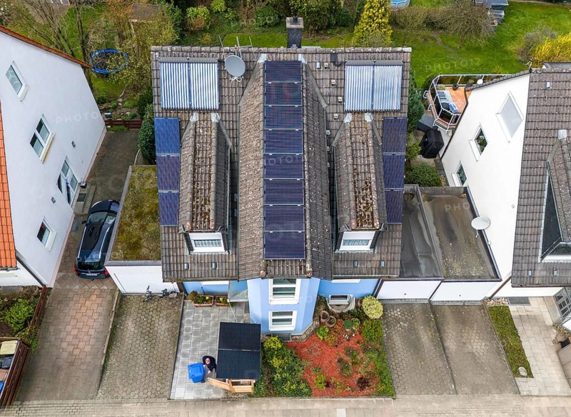 Detached house with various solar modules, in addition to normal standard solar panels, PV tube collectors are also installed, plug-in solar modules are mounted on a dustbin box as a roof, Essen, North Rhine-Westphalia, Germany, Europe
