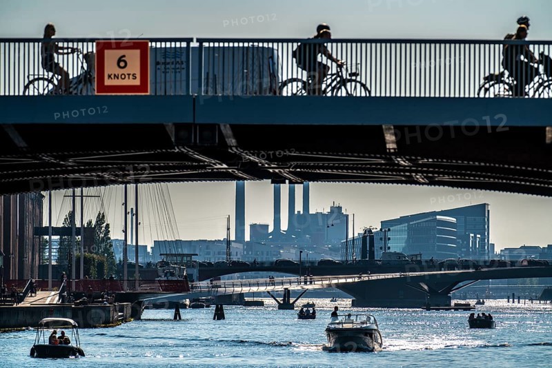 View over the harbour, in front left the Knippelsbro road bridge, behind it the Cirkelbroen bridge, the Lille Langebro cycle and footpath bridge, behind it the Langebro road bridge, in the background skyline at Sydhavnen, chimneys of the combined heat and power plant H.C. Ørstedsværket, Copenhagen, Denmark, Europe
