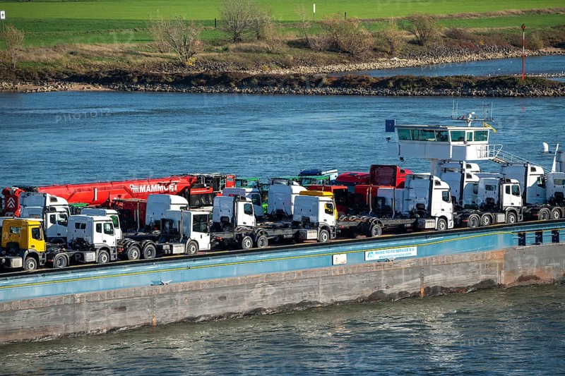 Cargo ship on the Rhine, near Krefeld, specialised freighter for vehicles, Vera/RoRo1 pushed convoy, transports new vehicles, here truck tractors and mobile cranes, from Mannheim to the overseas ports of Antwerp and Rotterdam, for the export of commercial vehicles, North Rhine-Westphalia, Germany, Europe