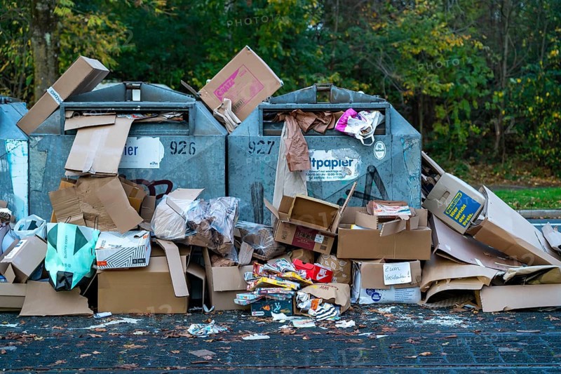 Overfilled waste paper containers, despite the overcrowding, people have put their waste paper next to them, Essen, North Rhine-Westphalia, Germany, Europe