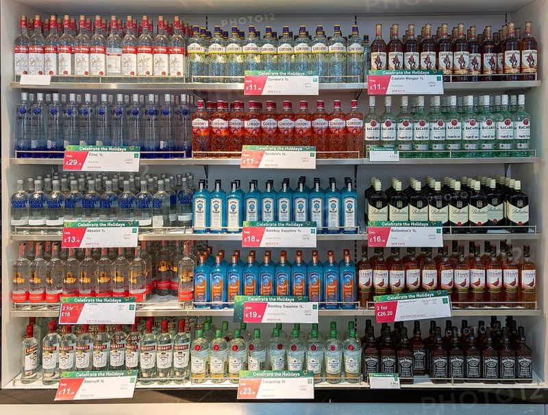 Shelves with bottles of alcohol World Duty Free shop, Stansted airport, Essex, England, UK