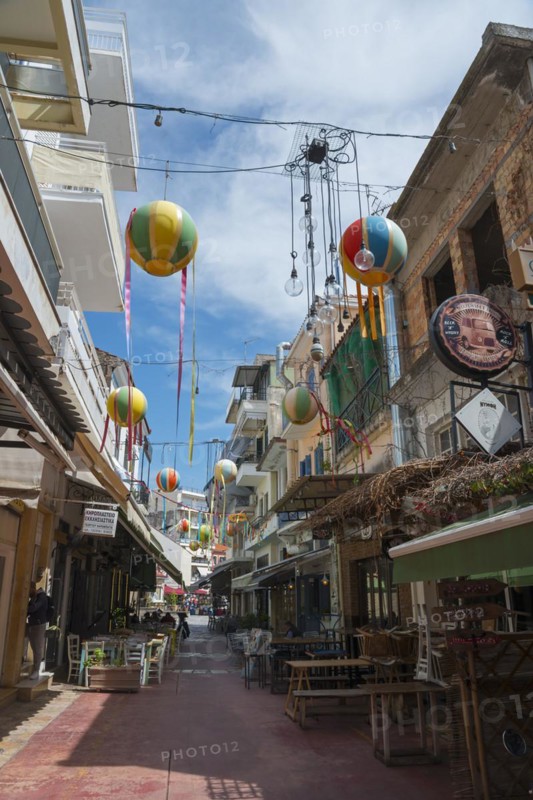 Narrow alley decorated with colourful hanging balloons, surrounded by shops, Kalamata, Messinia, Peloponnese, Greece, Europe