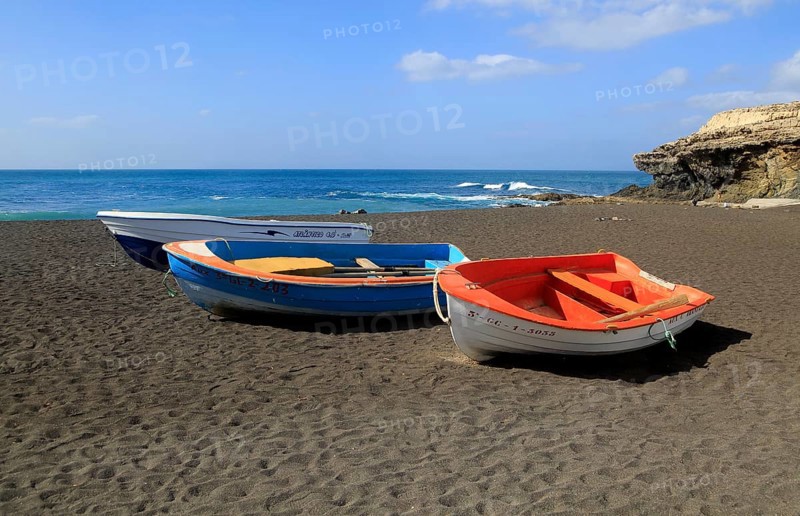 Colourful boats on black sand beach at Ajuy, Fuerteventura, Canary Islands, Spain, Europe