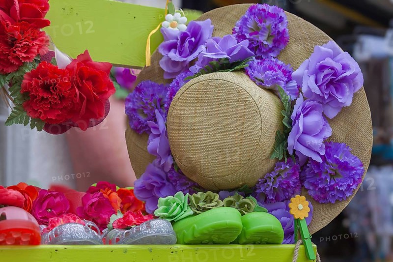 Straw hat decorated with artificial flowers in red and purple, Ile de Brehat, Brittany, France, Europe