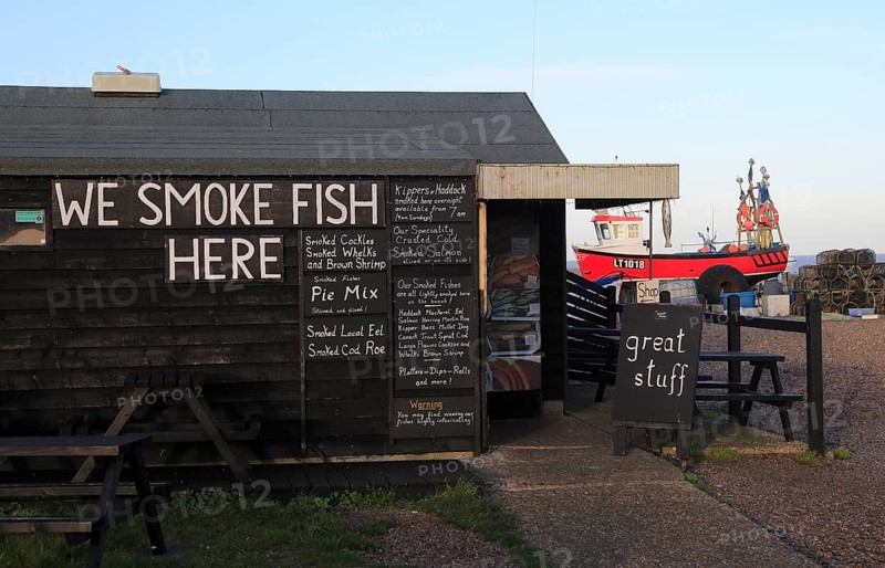 Sheds selling fresh and smoked fish on the beach at Aldeburgh, Suffolk, England, UK