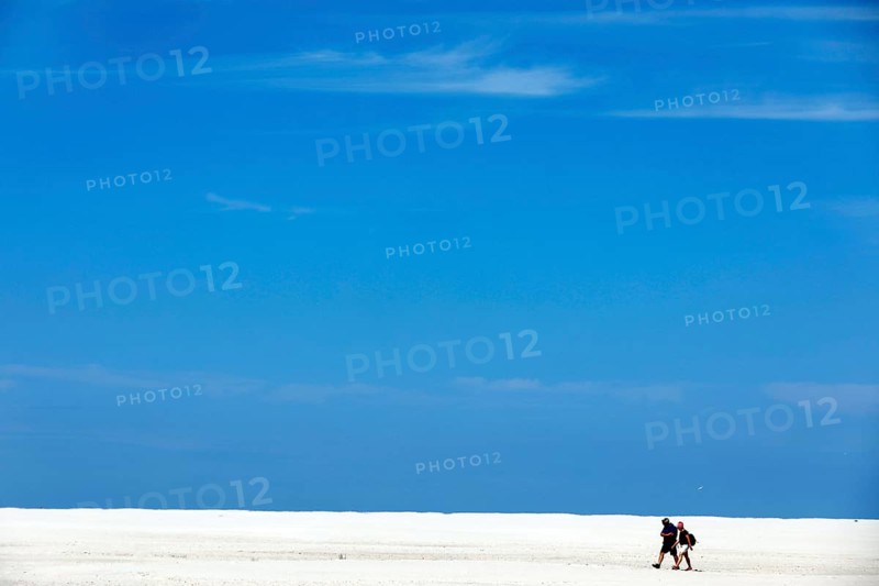 Holidaymakers walk through the Kniepsand on the beach of the island of Amrum, Wittdün, 18.06.2020
