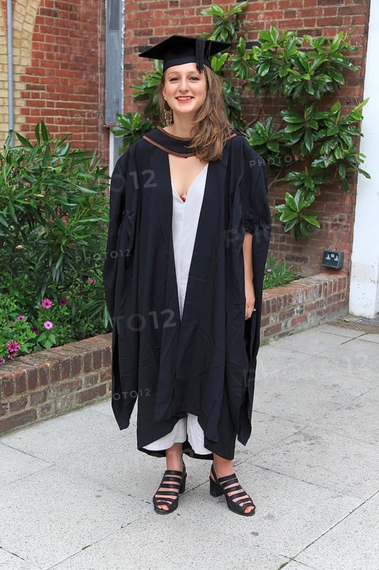 Full length portrait smiling young woman graduating, Goldsmiths College, University of London, England, UK