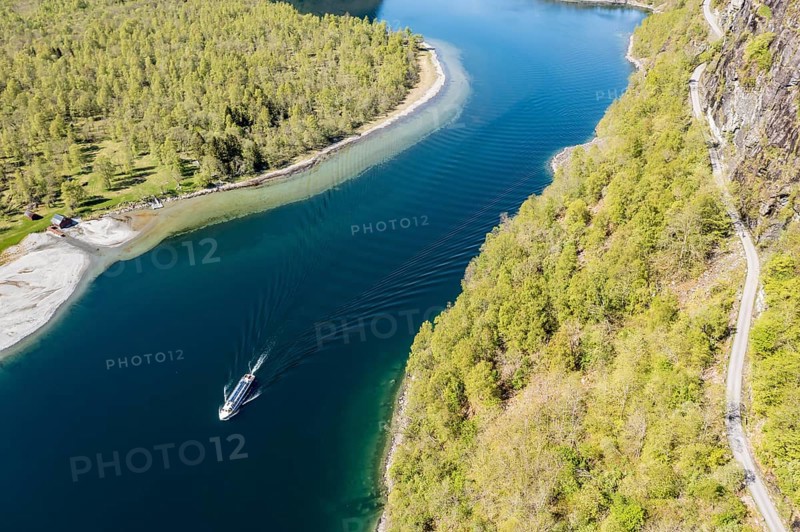 Aerial view of lake Lovatnet (or: Loenvatnet), local cruise ship on its way to Kjenndalstova, gravel mountain road above the lake, valley Lodalen south of village Loen, Norway, Europe