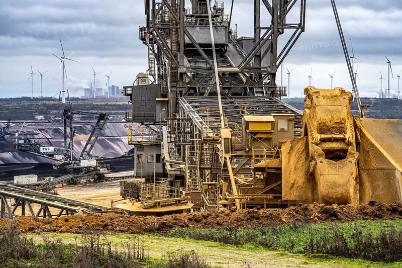 Opencast lignite mine Garzweiler 2, bucket wheel excavator 261 excavating the surface, at the rest of the hamlet of Lützerath, behind excavator 288, mining lignite, Neurath lignite-fired power station, wind farm, Erkelenz, North Rhine-Westphalia, Germany, Europe
