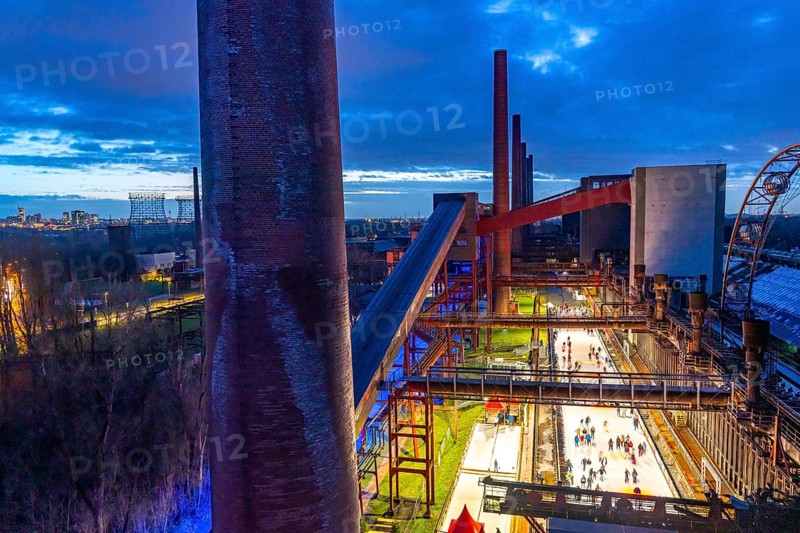 The ice rink at the Zollverein coking plant, Zollverein Coal Mine World Heritage Site, on the left the skyline of Essen city centre, North Rhine-Westphalia, Germany, Europe