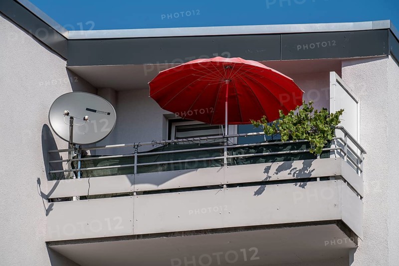 Balcony, balcony with parasol and TV satellite antenna and green plant, apartment blocks, Mülheim an der Ruhr, North Rhine-Westphalia, Germany, Europe