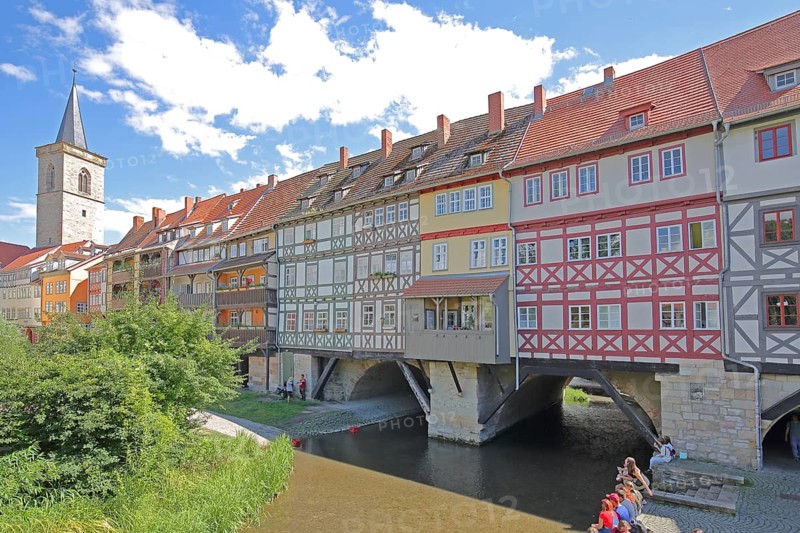 Famous Krämerbrücke and Gothic Ägidienkirche with river Gera and people sitting on the bank, idyll, half-timbered houses, bridge houses, church tower, Erfurt, Thuringia, Germany, Europe