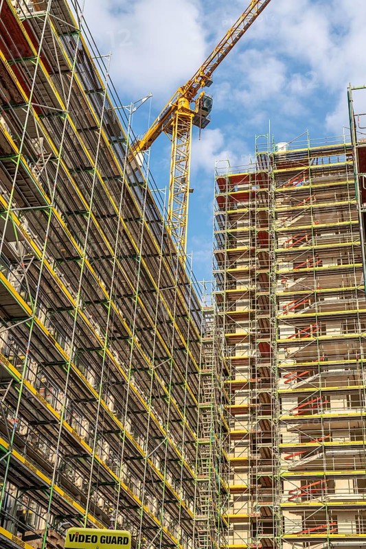 Construction site of a large building project on Huyssenallee in Essen, Huyssen Quartier, residential tower block with 19 floors, an office building with 5 floors, scaffolded new building, Essen, North Rhine-Westphalia, Germany, Europe