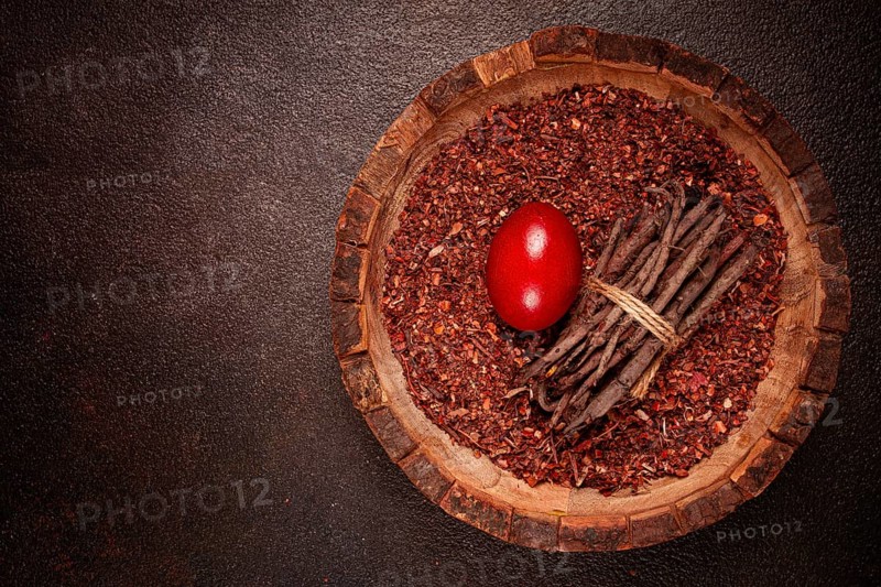 Madder dye, Endro, rhizome for coloring eggs, powder from the roots of endro with onion husks, in a wooden plate, top view, Easter, Georgia, Asia