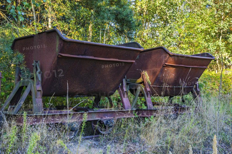 Old dilapidated rusty wagons of a light railway in an abandoned quarry, West Lusatia, Saxony, Germany, Europe