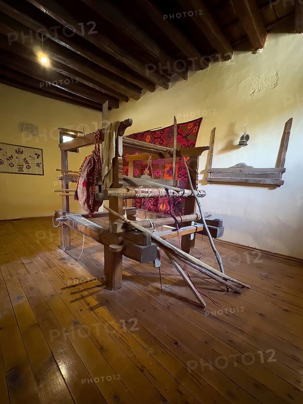 Room with traditional loom left on wall traditionally woven carpet in Xopatera Tower Tower of Xopateras from 19th century in Unesco Site Site Orthodox Greek Orthodox Monastery Moni Odigitria, Festos, Crete, Greece, Europe