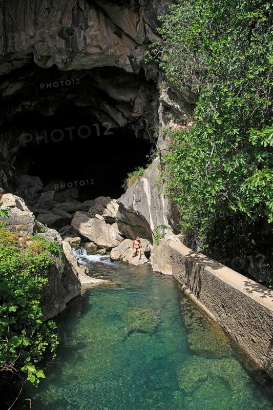 Person exploring entrance ot cave, Cueva del Gato, Benaojan, Serrania de Ronda, Malaga province, Spain, Europe