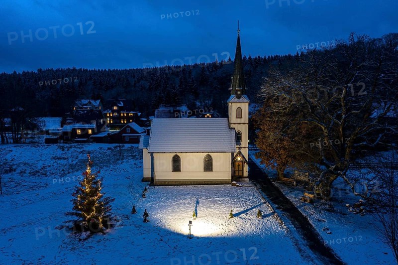 A Christmas tree stands in front of the smallest wooden church in Germany, Elend, 29 December 2020