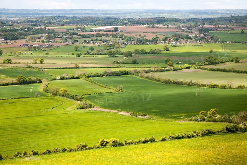 Summer view over patchwork of green fields looking east towards the distant Cotswolds, Roundway Hill, near Devizes, Wiltshire, England, United Kingdom, Europe