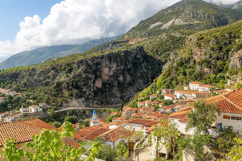 View over houses and rooftops to Greek Orthodox Church of Saint Spyridon, village of Dhermi, Albania, Europe