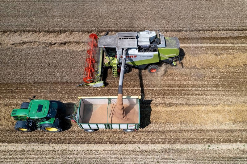 Agriculture, grain harvest, wheat, combine harvester harvesting in a wheat field, grain tank being emptied into a trailer, near Niederkrüchten, North Rhine-Westphalia, Germany, Europe