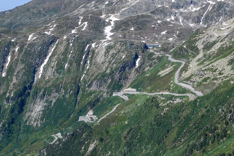 View of steep mountain road on slope above tree line with hairpin bends ascent to Grimsel Pass, Alps, Canton Valais, Switzerland, Europe