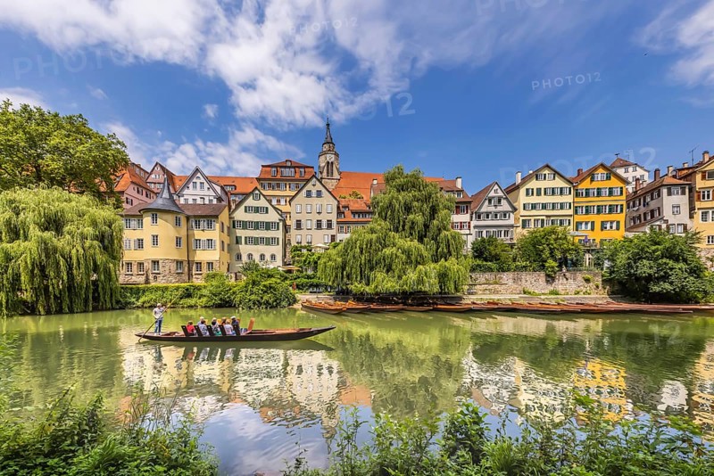 Neckarfront Tübingen with punt on the Neckar. Postcard motif with historic buildings, collegiate church and Hölderlin tower. Tübingen, Baden-Württemberg, Germany, Europe