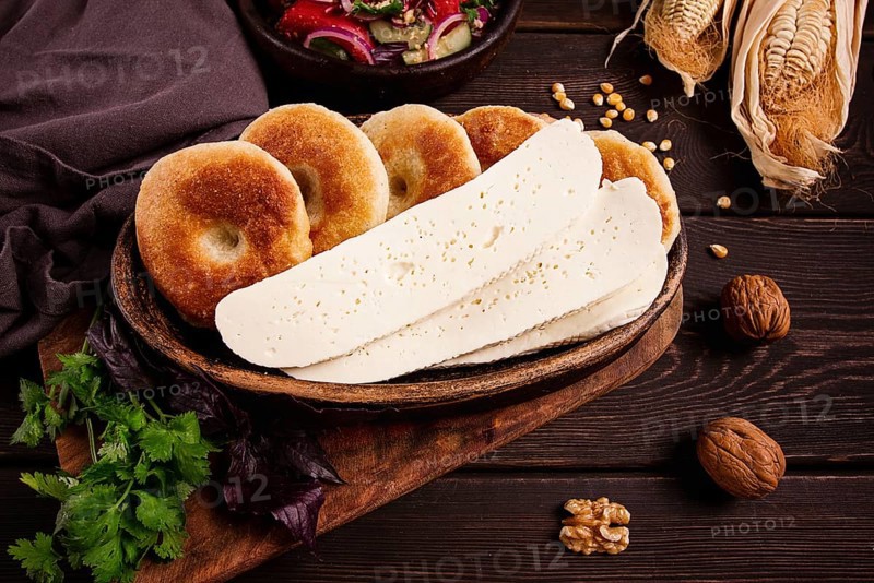 Mchadi, corn tortillas, traditional Georgian dish, corn bread, with Imeretian cheese, homemade, no people, on a wooden table