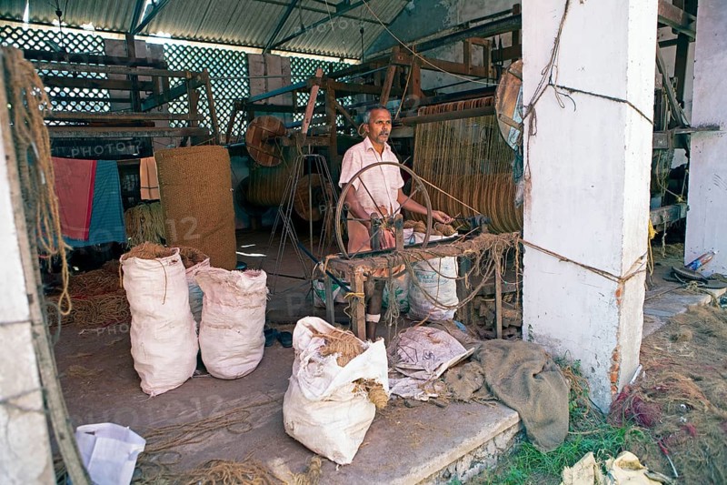 Indian worker winding coils in the Labourers Coir Mats and Mattings Cooperation, coir mat production, Muhamma, Alappuzha, Kerala, India, Asia