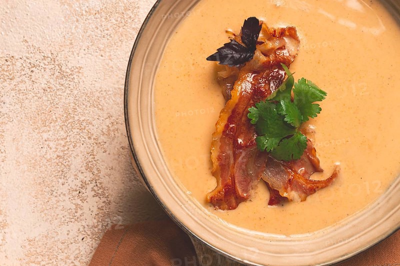 Pumpkin cream soup, curry, fried bacon, top view, no people