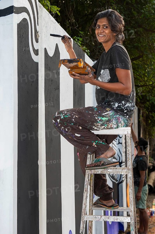Indian artist painting a wall during the international contemporary art exhibition Kochi-Muziris Biennale, Fort Cochin, Kochi, Kerala, South India, India, Asia