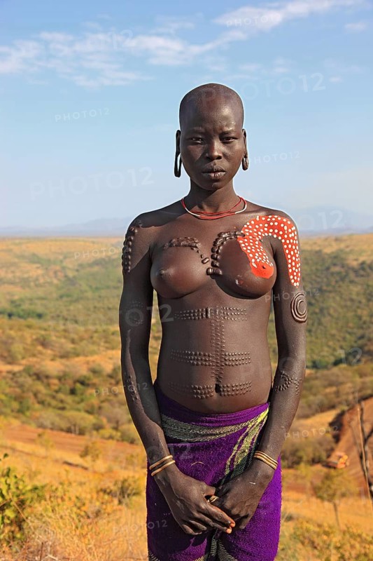 South Ethiopia, in the Maco National Park, woman from the Mursi tribe, Mursi woman with naked upper body and painted skin, Ethiopia, Africa