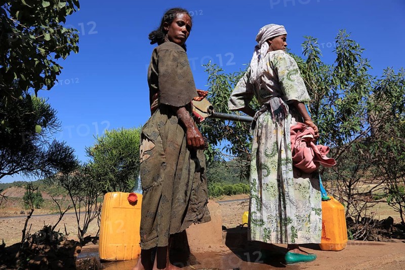 Amhara region, locals fetching water from a well, Ethiopia, Africa
