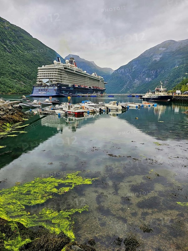 Large cruise ship, Mein Schiff 6 and boats sailing in a quiet fjord with green mountains and cloudy skies, Geiranger, Geiranger Fjord, Stranda, Romsdal, Norway, Europe