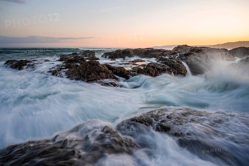 Waves washing over rocks by the sea, long exposure, coastal landscape at sunset, Playa Cocalito, Pacific coast, Nicoya Peninsula, Puntarenas province, Costa Rica, Central America