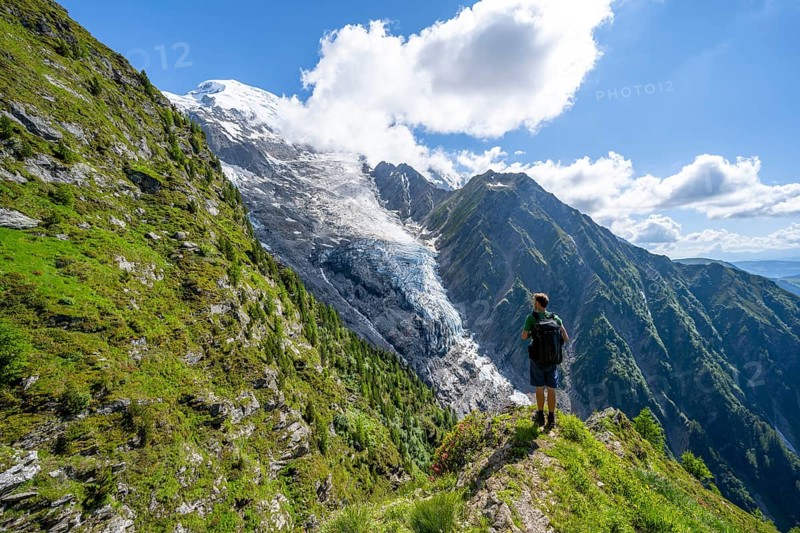 Mountaineer in front of impressive mountain landscape with glacier, view of glacier Glacier de Taconnaz, hike La Jonction, Chamonix, Haute-Savoie, France, Europe