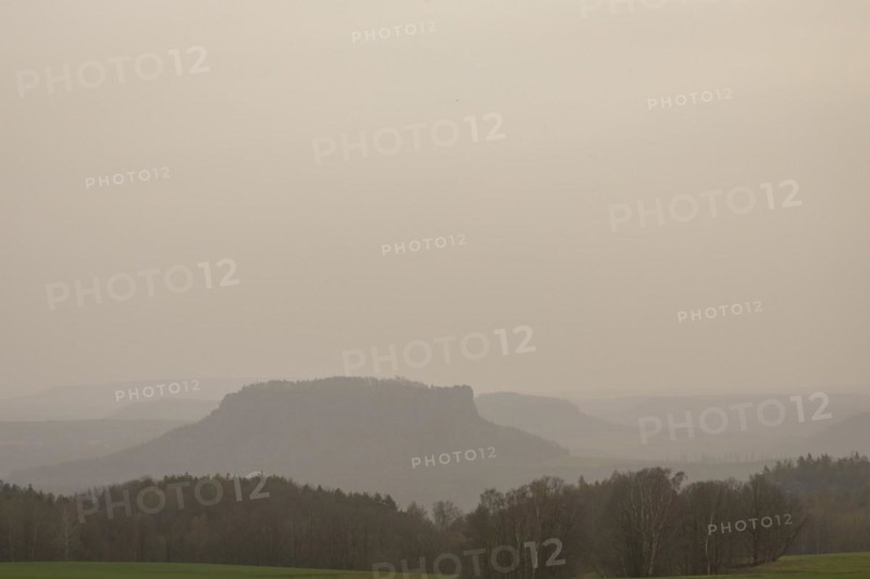 Large amounts of Sahara dust obscure the sun and cloud the distant view to Lilienstein and Pfaffenstein, Rathewalde, Saxony, Germany, Europe