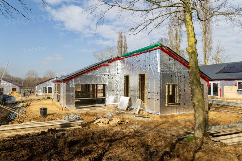 Building site single storey bungalow homes, timber frame construction, thermal insulation, Ufford, Suffolk, England, UK