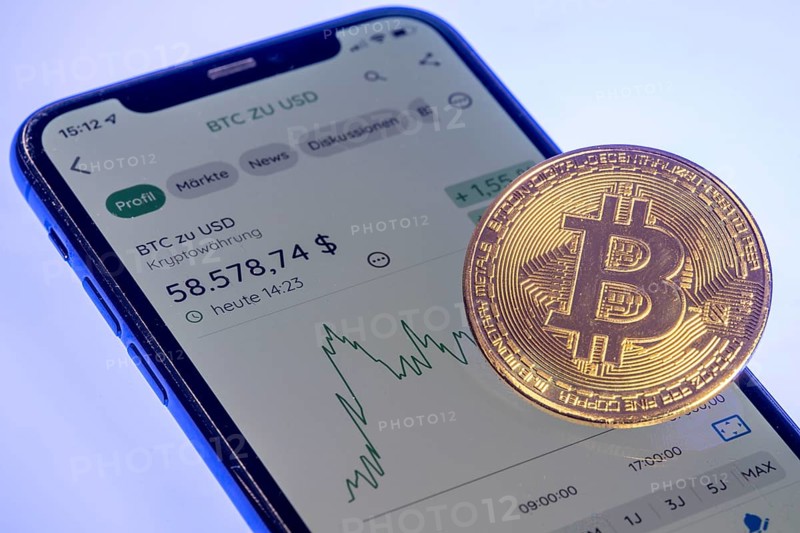 Bitcoin cryptocurrency, symbol coin, mobile phone, mobile phone with Bitcoin currency rates, to the US dollar, optical placeholder for the digital currency, blockchain, stock exchange rates