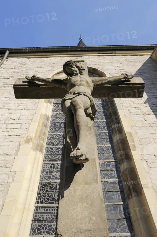 Jesus Christ on the cross in front of the parish church of St Christophorus, Werne, North Rhine-Westphalia, Germany, Europe