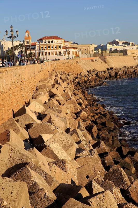 Coastal view east of rock armour coastal defences near city centre, Cadiz, Spain, Europe