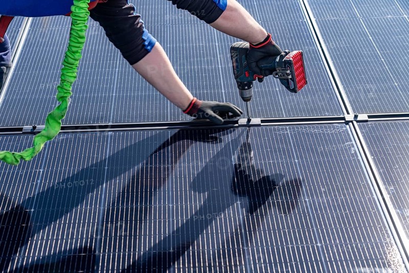 Installation of solar modules on the roof of a commercial enterprise, over 400 photovoltaic modules are installed on the roof, North Rhine-Westphalia, Germany, Europe